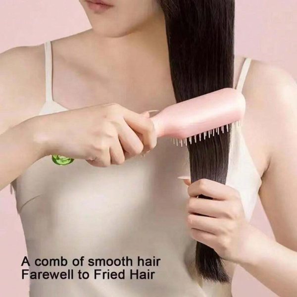 Woman using easy clean hairbrush